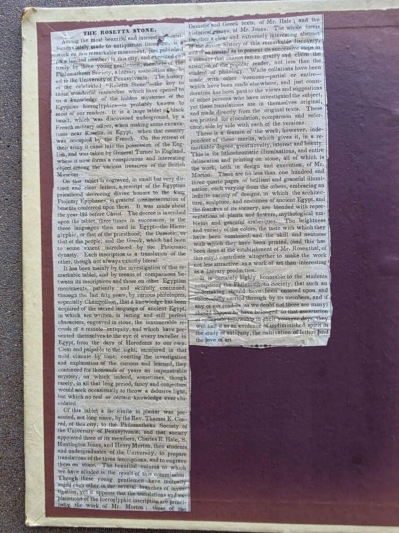 C044 full mounted newspaper review headed The Rosetta Stone